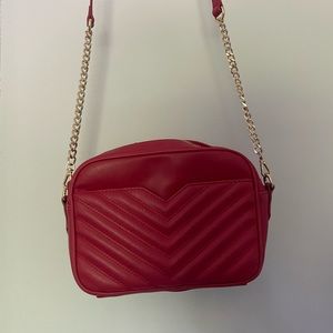 Express red chevron bag with gold chain.